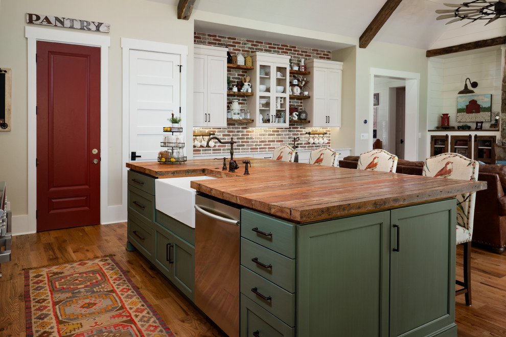 Mid-sized country galley eat-in kitchen in Atlanta with a farmhouse sink, recessed-panel cabinets, beige cabinets, red splashback, brick splashback, stainless steel appliances, medium hardwood floors, with island, brown floor and wood benchtops.