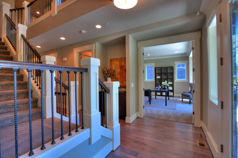 Photo of a mid-sized transitional foyer in Seattle with grey walls, medium hardwood floors, a single front door and a white front door.
