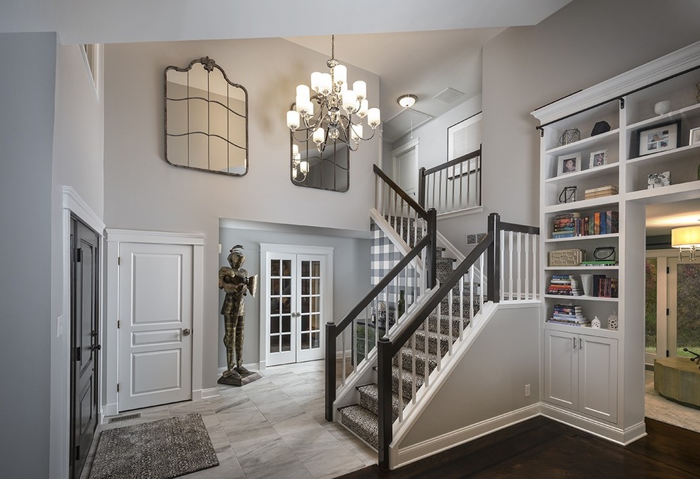 Inspiration for a mid-sized traditional foyer in Philadelphia with grey walls, ceramic floors, a single front door, a black front door, grey floor, vaulted and panelled walls.