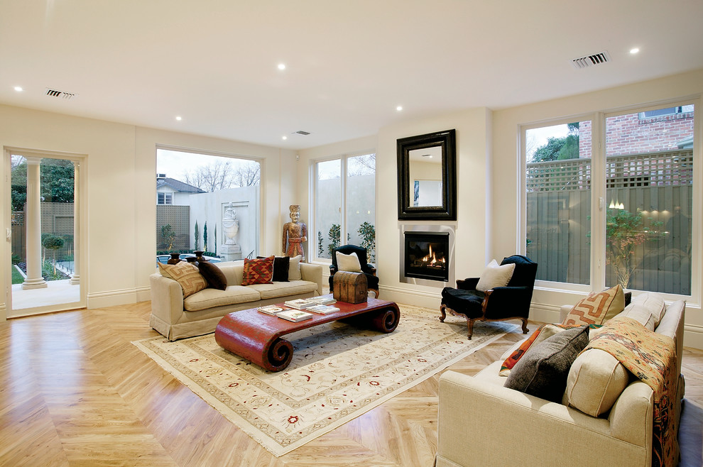 This is an example of a mid-sized transitional formal enclosed living room in Melbourne with beige walls, a standard fireplace and no tv.
