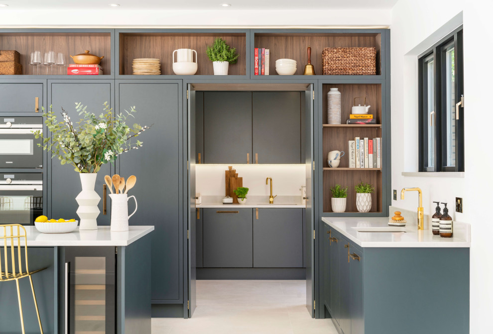 Photo of a contemporary u-shaped kitchen in London with an undermount sink, flat-panel cabinets, grey cabinets, panelled appliances, with island and white floor.