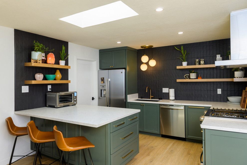 Kitchen - small scandinavian l-shaped light wood floor and brown floor kitchen idea in Sacramento with an undermount sink, shaker cabinets, green cabinets, quartz countertops, black backsplash, subway tile backsplash, stainless steel appliances, an island and white countertops