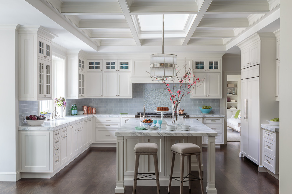 Design ideas for a traditional l-shaped kitchen in San Francisco with shaker cabinets, white cabinets, blue splashback, subway tile splashback, panelled appliances, dark hardwood floors, with island and brown floor.