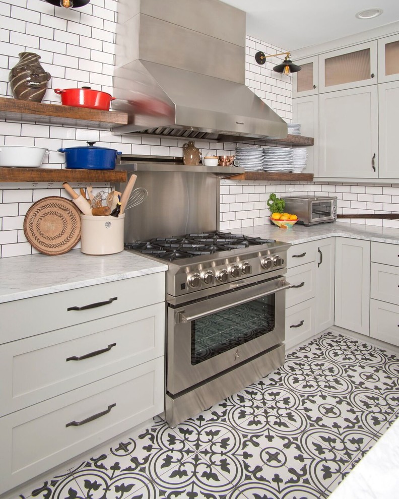 Inspiration for a mid-sized transitional u-shaped ceramic tile and multicolored floor eat-in kitchen remodel with a farmhouse sink, marble countertops, white backsplash, subway tile backsplash, stainless steel appliances, an island, gray cabinets and shaker cabinets