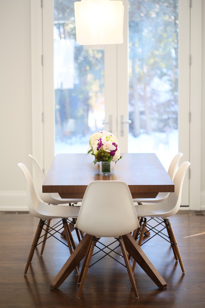 Photo of a contemporary dining room in Toronto with white walls and dark hardwood floors.