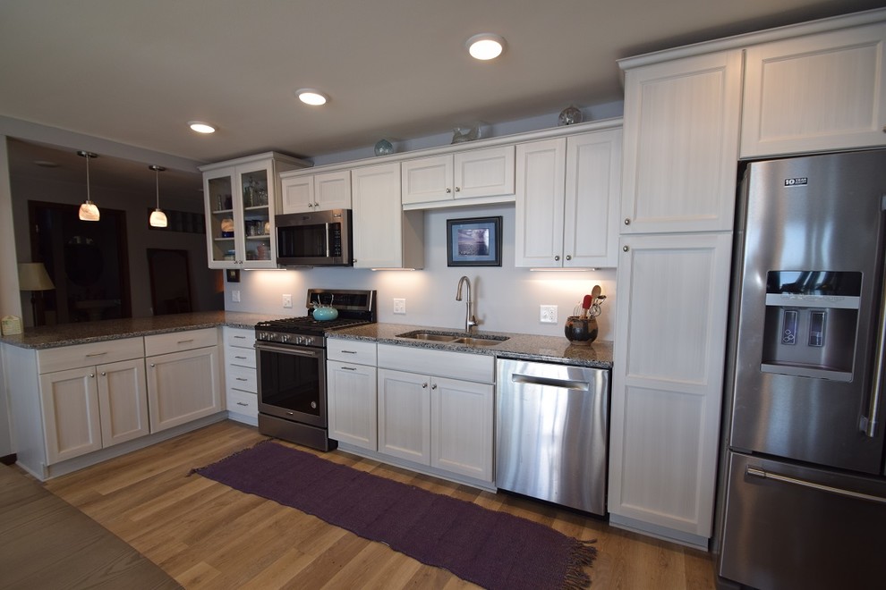 Inspiration for a transitional vinyl floor kitchen remodel with an undermount sink, white cabinets, granite countertops, stainless steel appliances and no island