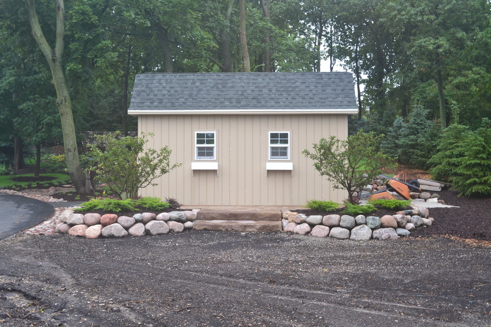 Large mountain style front yard concrete home design photo in Milwaukee with a fire pit and no cover