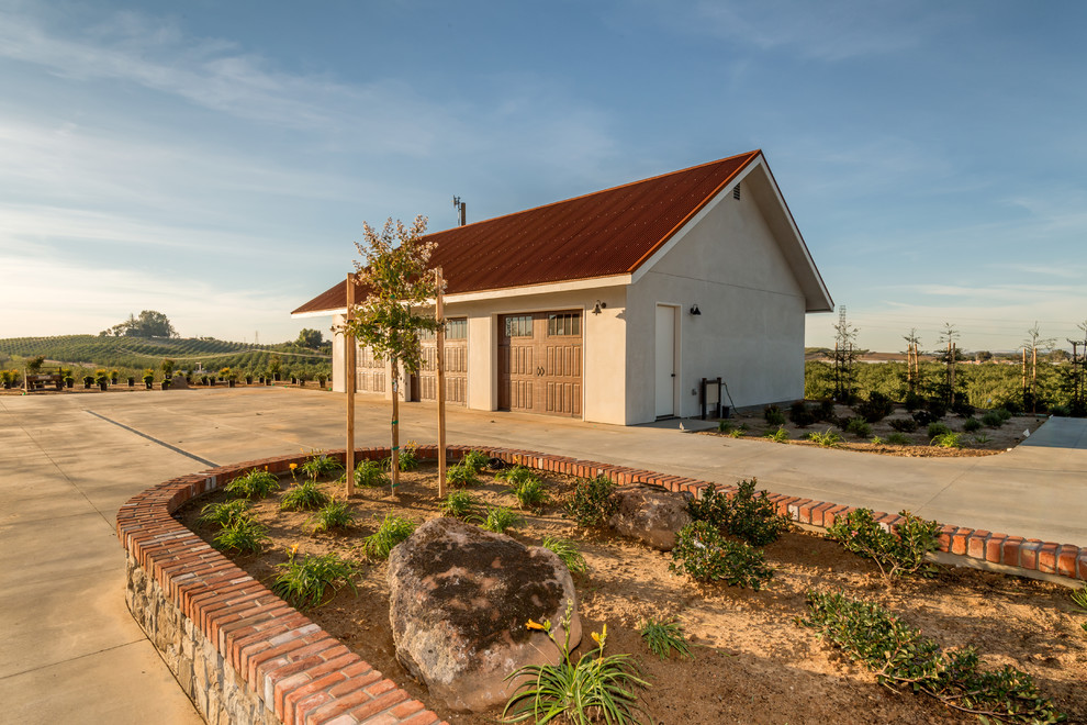 Example of a large mountain style detached three-car garage design in Sacramento