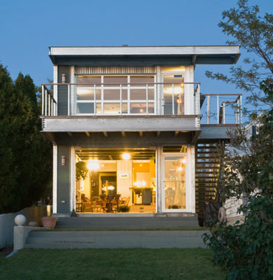Photo of a large contemporary two-storey grey house exterior in Burlington with mixed siding and a flat roof.