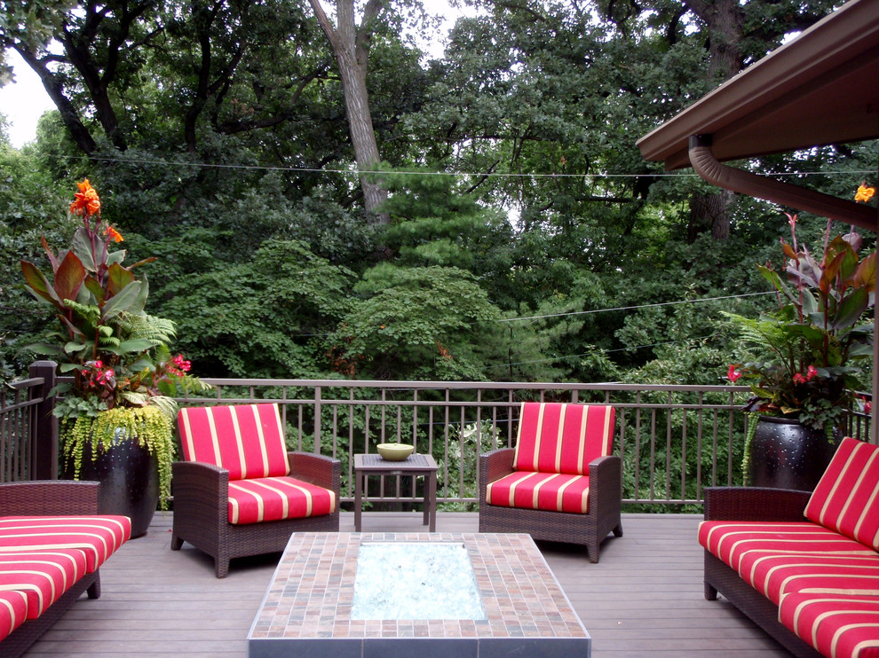 Large contemporary backyard deck in Omaha with no cover and a fire feature.