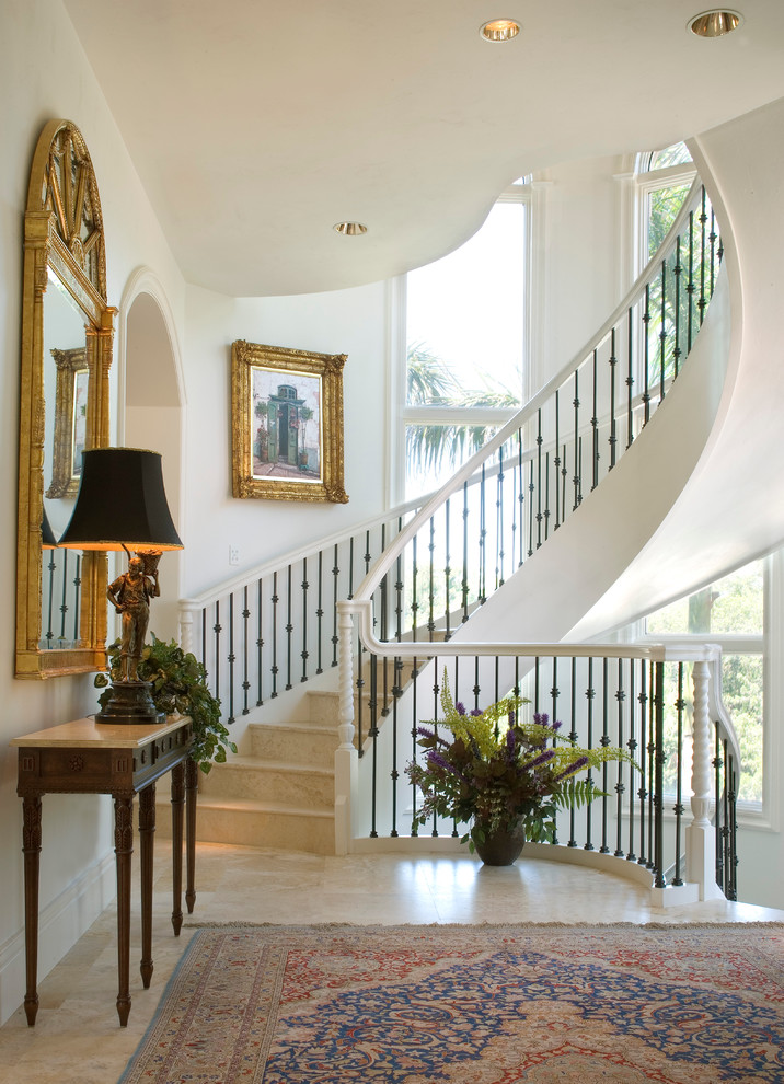 Design ideas for a mediterranean curved staircase in Miami with mixed railing.