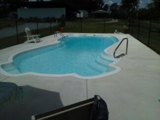 Example of a mid-sized backyard freeform indoor pool design