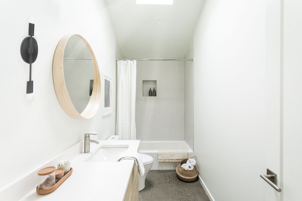 This is an example of a small scandinavian master bathroom in Portland with brown cabinets, a one-piece toilet, white walls, grey floor and white benchtops.