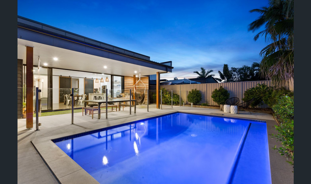 Photo of a mid-sized contemporary backyard pool in Gold Coast - Tweed with tile.