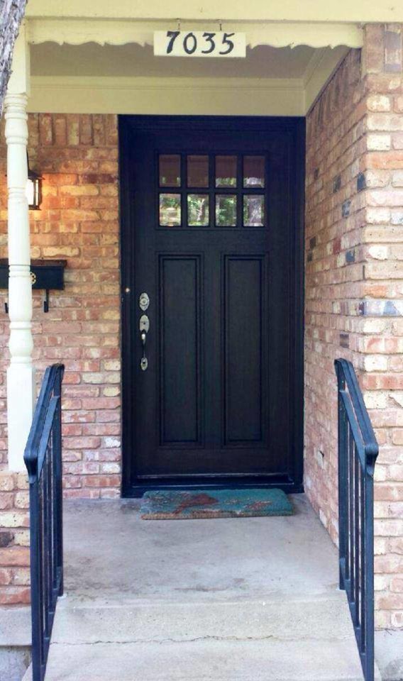 This is an example of a mid-sized traditional front door in Dallas with a single front door and a black front door.