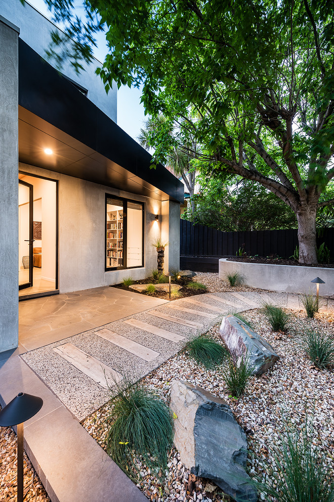 Mid-sized contemporary front yard partial sun xeriscape in Melbourne with gravel.