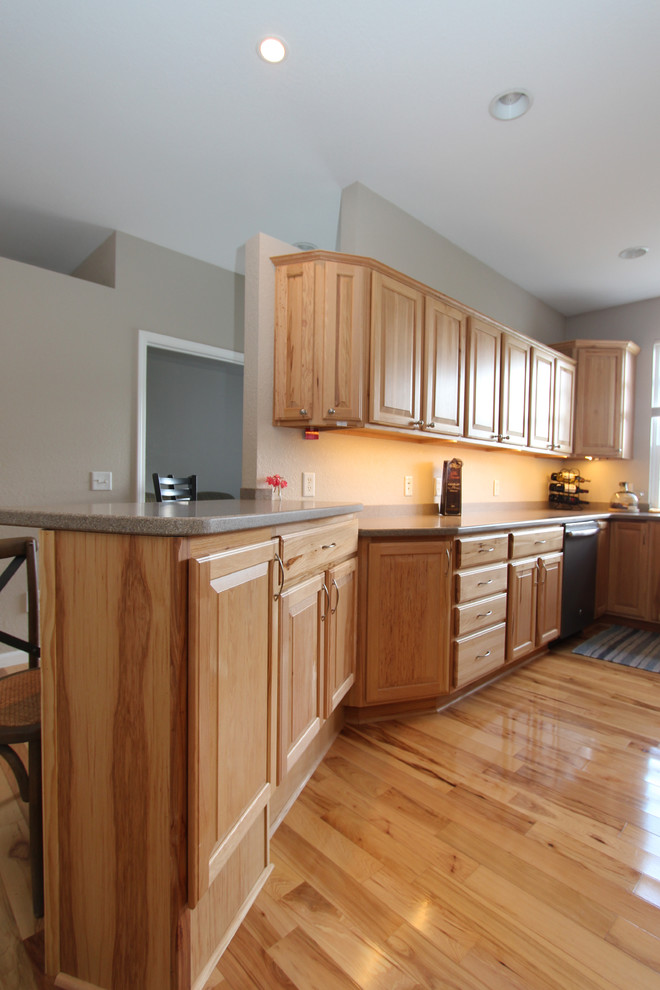 Inspiration for a mid-sized transitional light wood floor eat-in kitchen remodel in Grand Rapids with beige walls, a standard fireplace and a wood fireplace surround