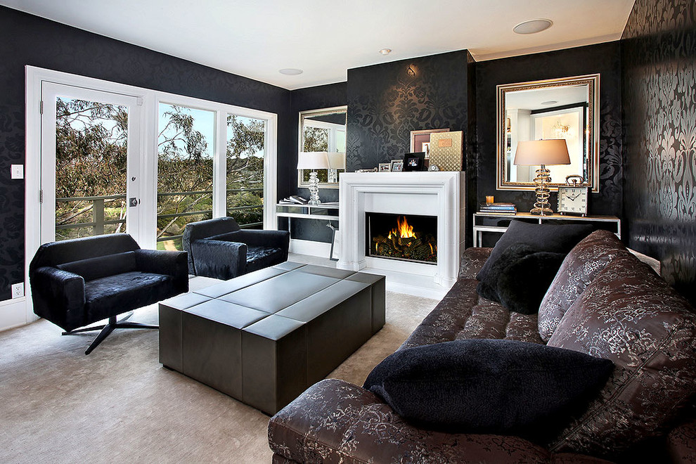 Mid-sized contemporary enclosed living room in Los Angeles with black walls, light hardwood floors, a standard fireplace and a plaster fireplace surround.