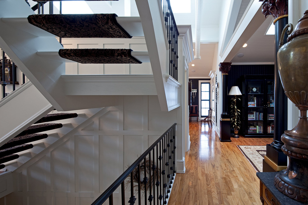 This is an example of a contemporary hallway in Toronto with white walls and medium hardwood floors.