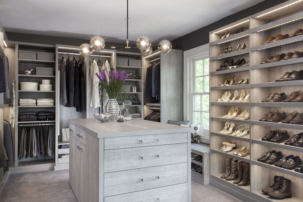 Design ideas for a large transitional gender-neutral dressing room in New York with flat-panel cabinets, distressed cabinets and carpet.