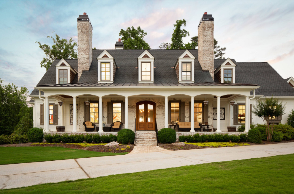 Design ideas for a traditional two-storey brick white house exterior in Atlanta with a gable roof, a mixed roof and a grey roof.