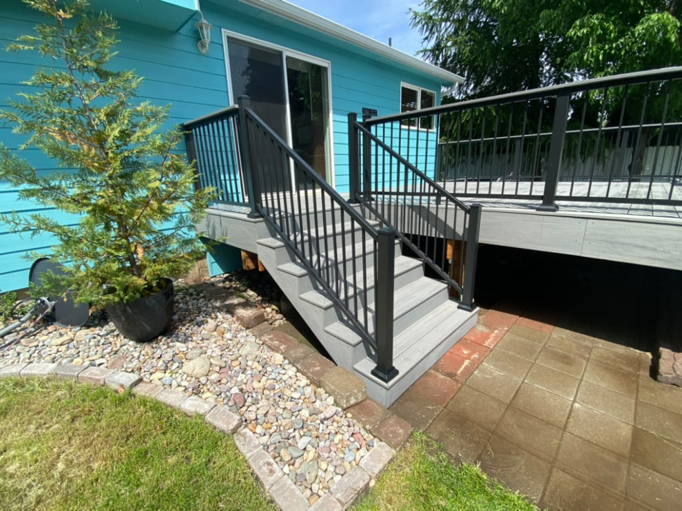 Deck - large backyard metal railing deck idea in Seattle