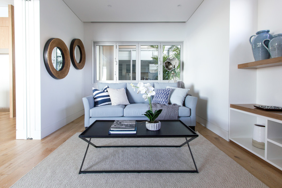Photo of a contemporary open concept living room in Sydney with white walls.