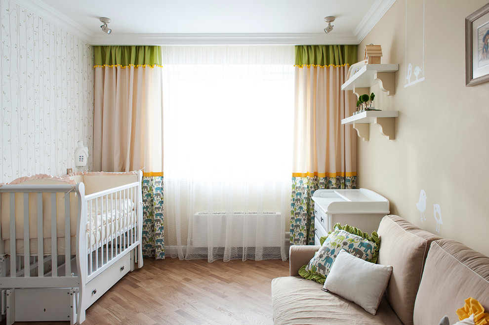 Cette photo montre une chambre de bébé avec un mur beige et un sol en bois brun.