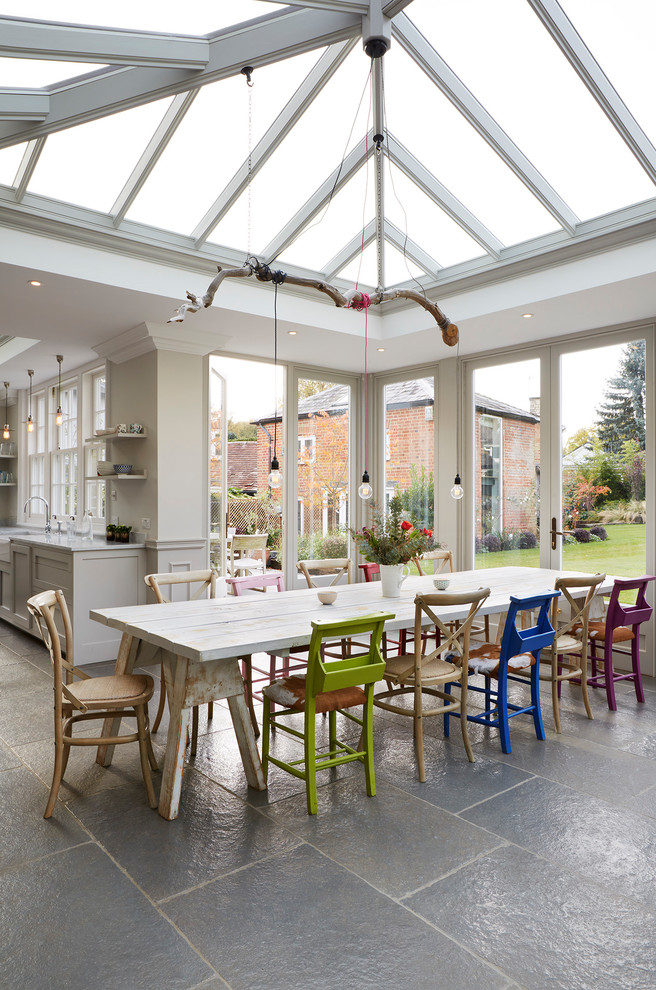 Photo of a large eclectic open plan dining in Essex with beige walls and grey floor.