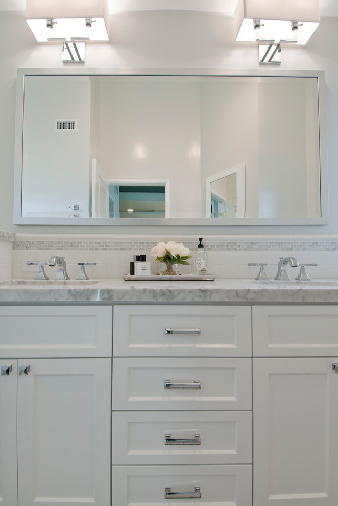 Design ideas for a mid-sized transitional master bathroom in Los Angeles with recessed-panel cabinets, white cabinets, an alcove tub, a shower/bathtub combo, a two-piece toilet, white tile, subway tile, grey walls, porcelain floors, an undermount sink and marble benchtops.