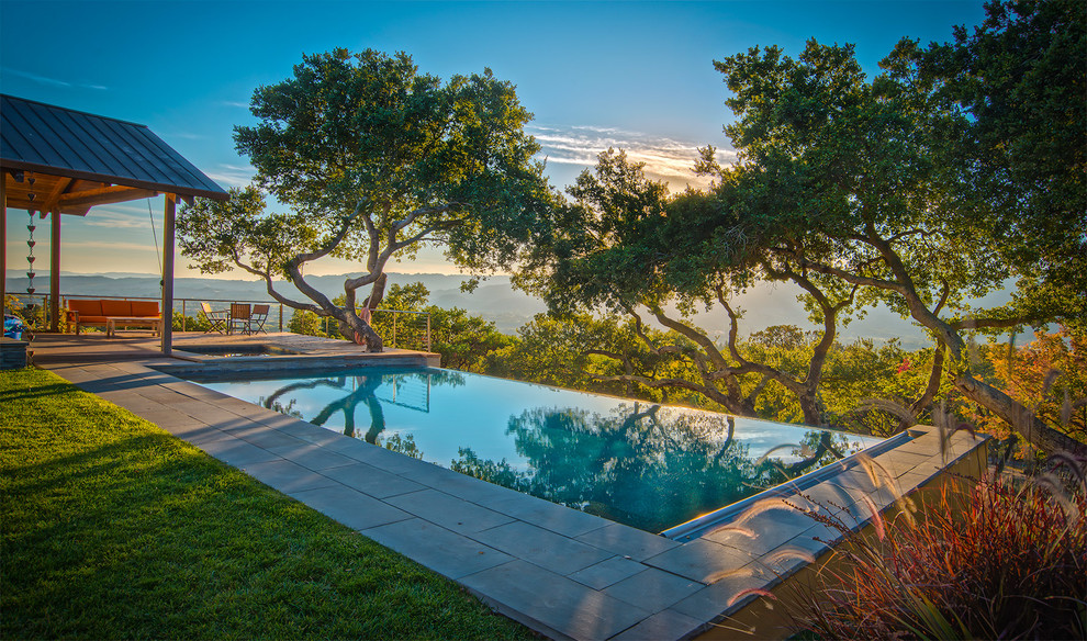 Inspiration for a contemporary pool in San Francisco with natural stone pavers.