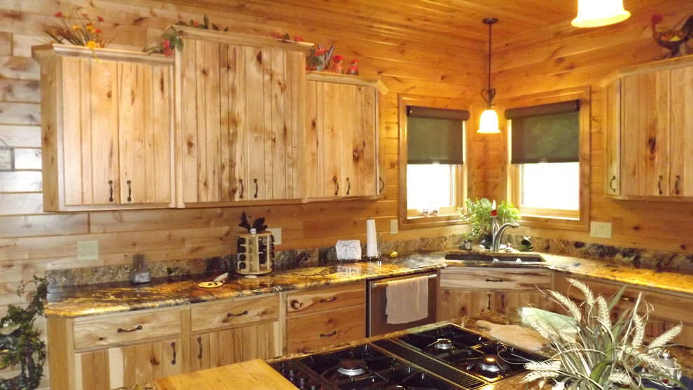 Inspiration for a rustic u-shaped porcelain tile and brown floor enclosed kitchen remodel with an undermount sink, stainless steel appliances and an island