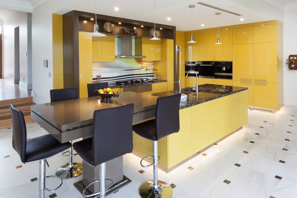 Modern l-shaped kitchen in Perth with an undermount sink, flat-panel cabinets, yellow cabinets, granite benchtops, multi-coloured splashback, glass sheet splashback, stainless steel appliances, multiple islands and multi-coloured benchtop.