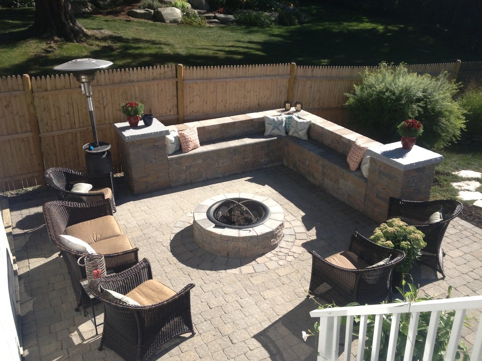 Photo of a small contemporary backyard patio in Boston with a fire feature and concrete pavers.