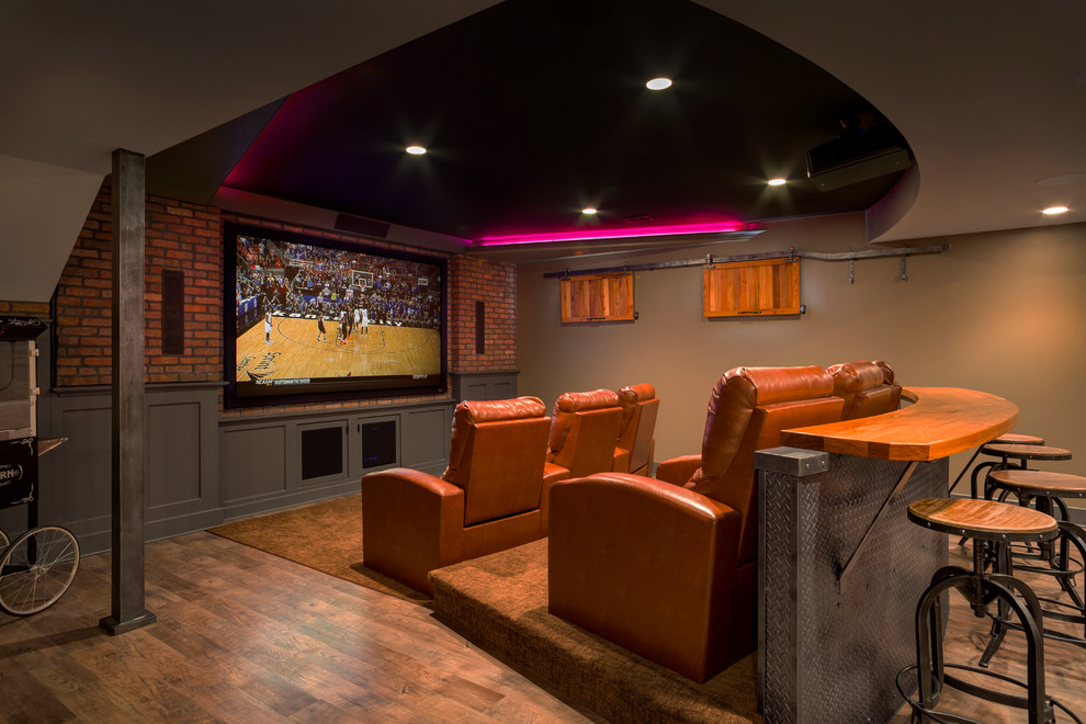 Traditional home theatre in Kansas City with brown walls, medium hardwood floors and brown floor.