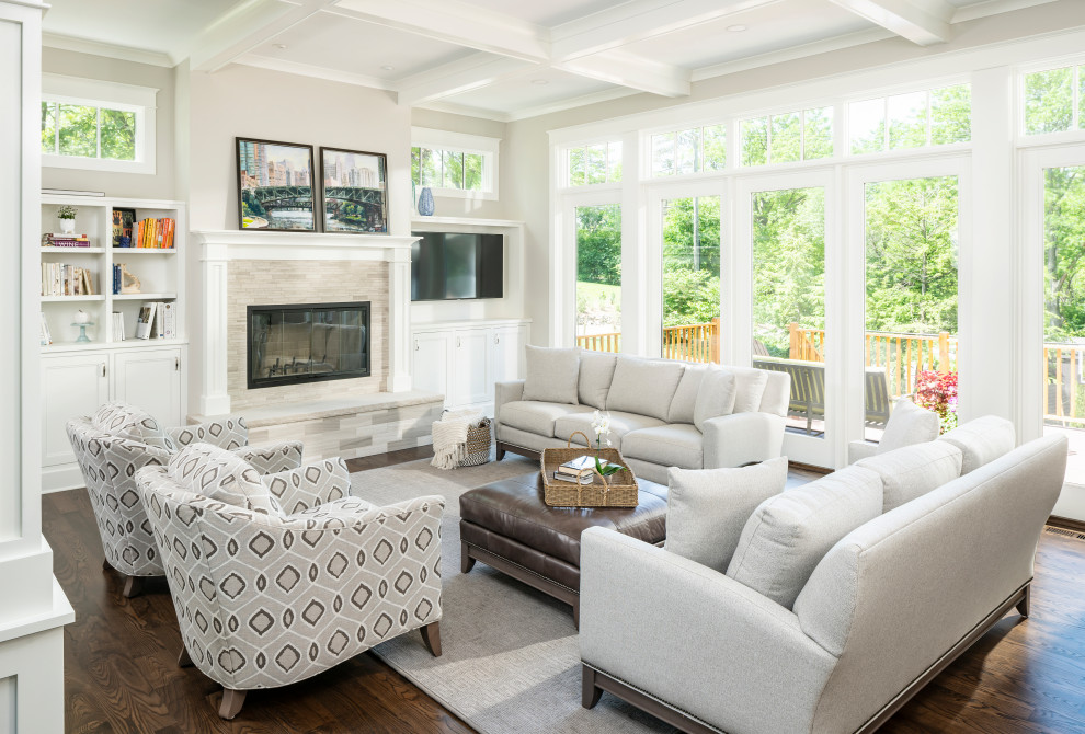 Design ideas for a large transitional open concept living room in Detroit with beige walls, a standard fireplace, a tile fireplace surround, a wall-mounted tv, brown floor, coffered and dark hardwood floors.