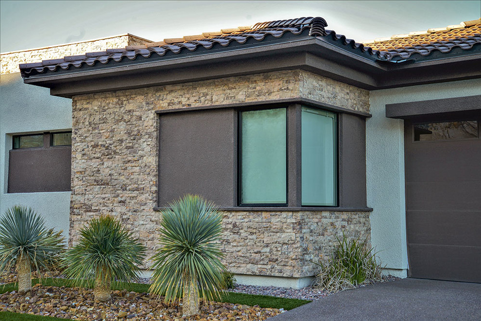 Large modern two-storey brown exterior in Las Vegas with stone veneer.