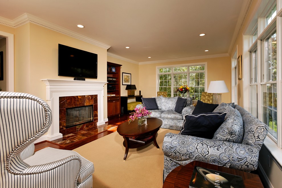 This is an example of a traditional family room in DC Metro with yellow walls.