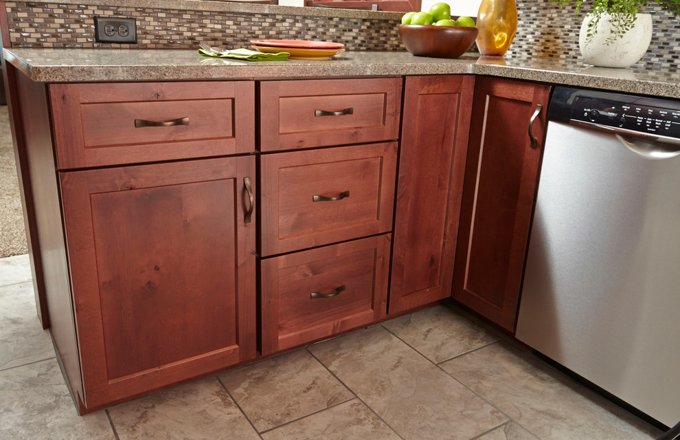 Example of a transitional u-shaped kitchen design with an undermount sink, shaker cabinets, medium tone wood cabinets, beige backsplash, stainless steel appliances and no island