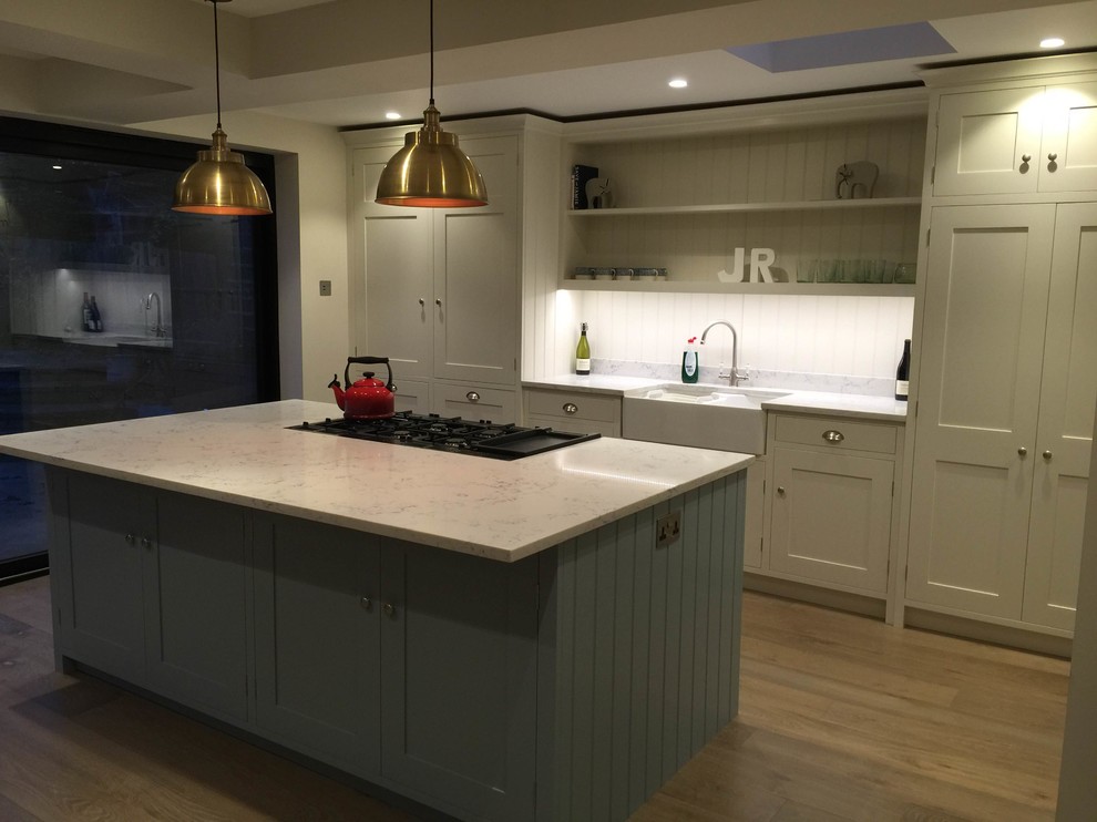 Inspiration for a mid-sized traditional single-wall open plan kitchen in Surrey with a double-bowl sink, shaker cabinets, blue cabinets, quartzite benchtops, stainless steel appliances and with island.