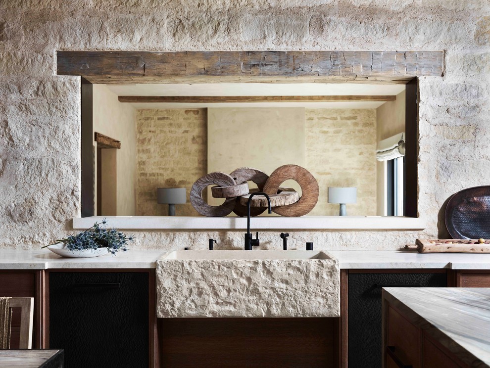 Country kitchen in San Francisco with a farmhouse sink, flat-panel cabinets, granite benchtops and travertine floors.