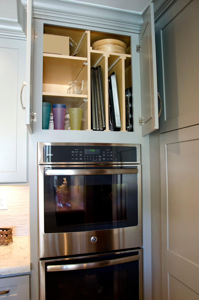 Inspiration for a mid-sized transitional u-shaped open concept kitchen remodel in Miami with an undermount sink, shaker cabinets, gray cabinets, quartzite countertops, gray backsplash, porcelain backsplash, stainless steel appliances and an island