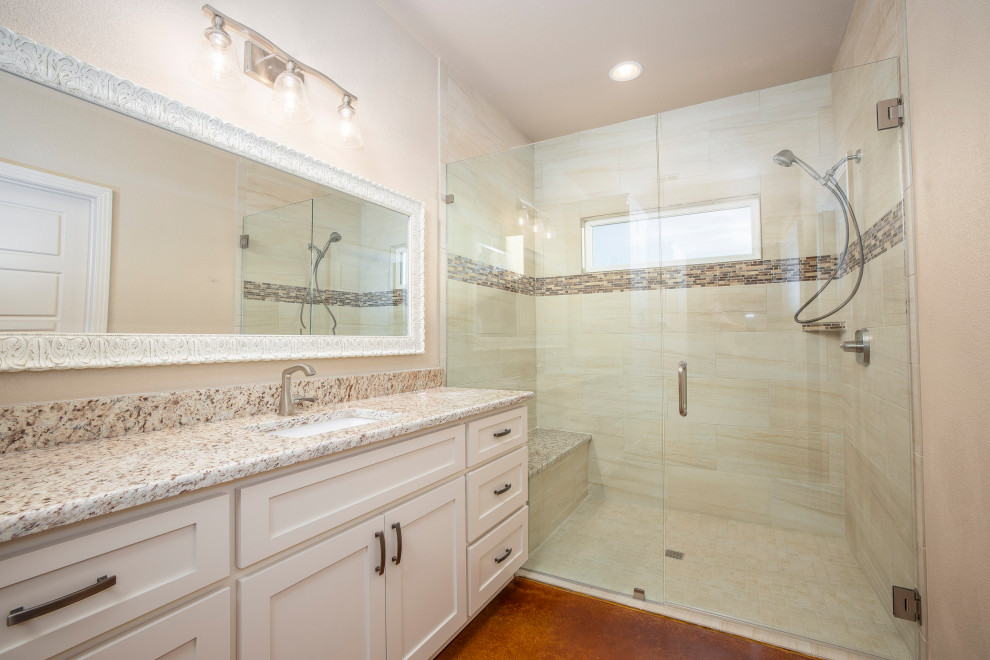 This is an example of a large country 3/4 bathroom in Austin with flat-panel cabinets, white cabinets, beige tile, granite benchtops, multi-coloured benchtops, a single vanity, a built-in vanity, a double shower, mosaic tile, white walls, concrete floors, an undermount sink, brown floor, a hinged shower door and a shower seat.