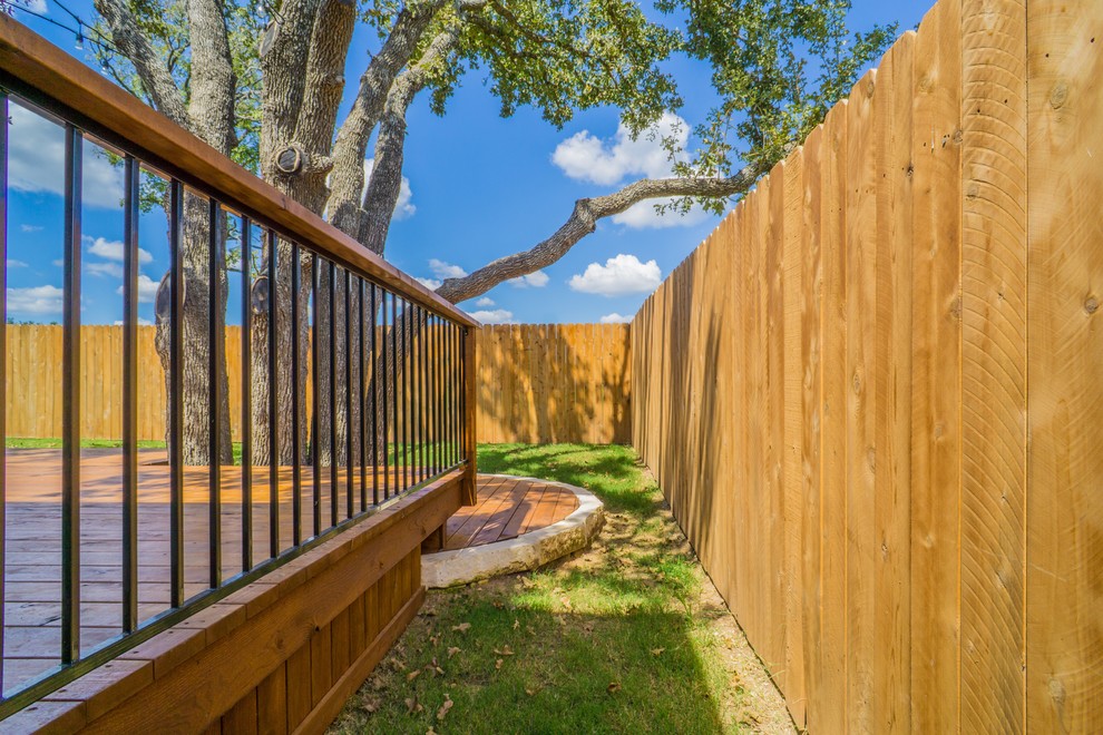 Mid-sized transitional backyard home design photo in Austin with a roof extension