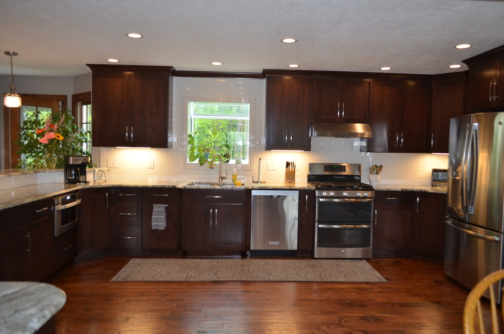 Mid-sized transitional u-shaped dark wood floor eat-in kitchen photo with a double-bowl sink, dark wood cabinets, soapstone countertops, white backsplash, subway tile backsplash, stainless steel appliances and no island