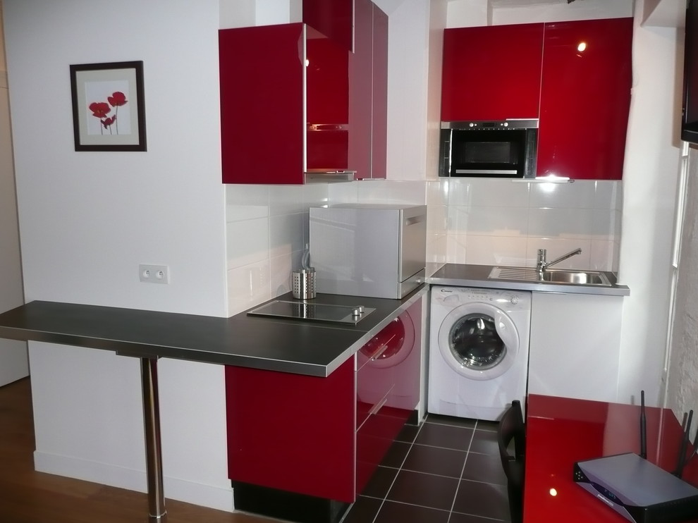 Small contemporary l-shaped eat-in kitchen in Paris with an undermount sink, beaded inset cabinets, red cabinets, laminate benchtops, white splashback, ceramic splashback, white appliances, ceramic floors, no island and black floor.