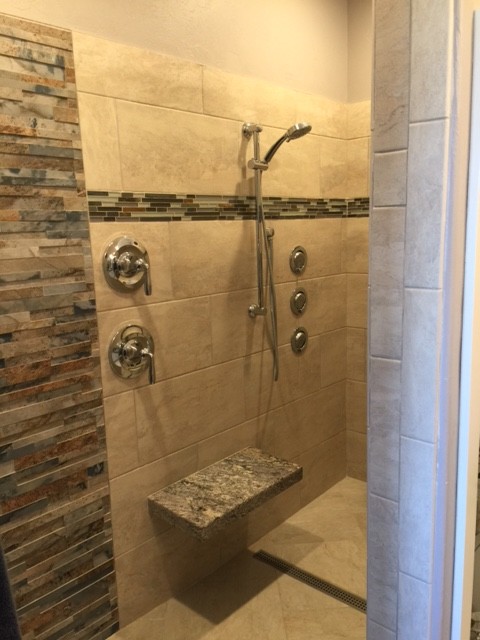 Doorless shower - mid-sized transitional master multicolored tile and mosaic tile ceramic tile and beige floor doorless shower idea with raised-panel cabinets, white cabinets, a two-piece toilet, gray walls, a vessel sink and granite countertops