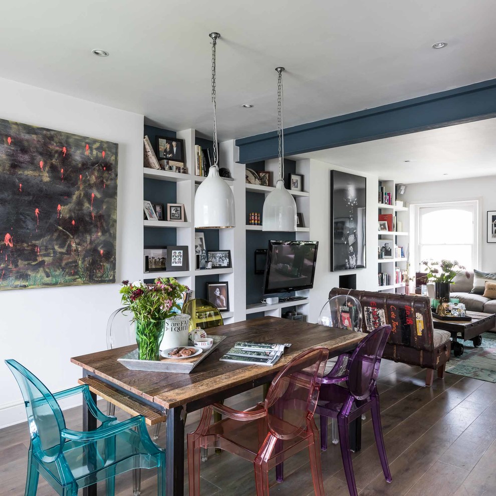 Photo of an eclectic open plan dining in London with white walls and dark hardwood floors.
