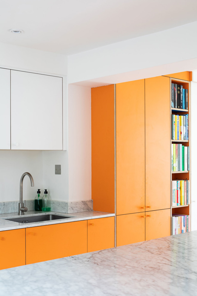 Design ideas for a large contemporary u-shaped enclosed kitchen in London with an integrated sink, flat-panel cabinets, orange cabinets, stainless steel appliances and an island.