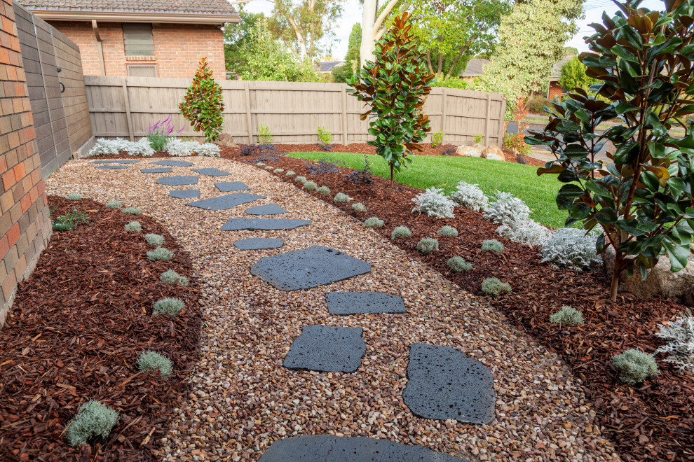 Small contemporary front yard full sun xeriscape with natural stone pavers for fall.